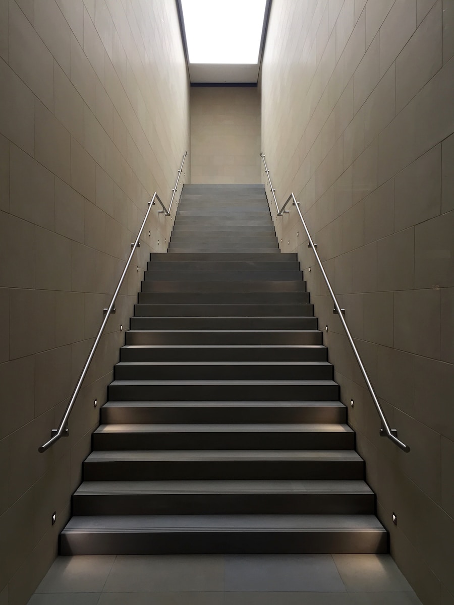 gray concrete stair with gray steel handle